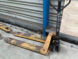 a pallet that is sitting on the ground next to a building