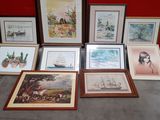 a lot of framed pictures on the floor next to a red wall