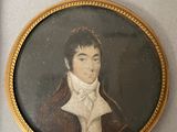 portrait of a young man in a brown coat and white shirt in a gold frame