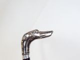 a close up of a walking stick with a dog head on it