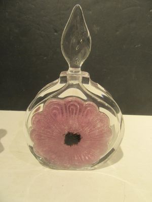 a glass vase with a pink flower inside of it