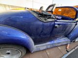 a blue car that is parked on the side of the road