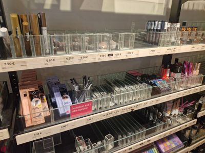 a lot of makeup products on the shelves in the store