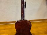 a guitar that is sitting on a stand on the floor