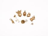 gold plated charms on a white background