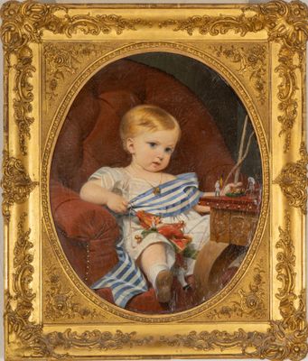 portrait of a young boy in a blue striped dress holding a toy