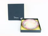 a box with a cake inside of it on a white surface