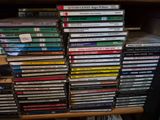 many dvds stacked on top of each other on a shelf
