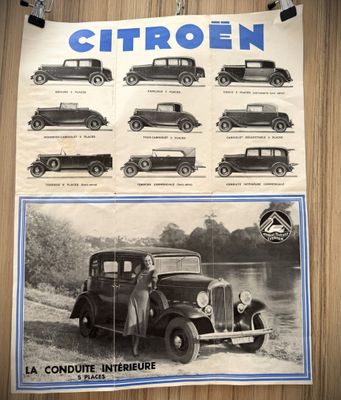 a poster of old cars on the wall of a building