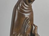 statue of a woman holding a bird in her hands