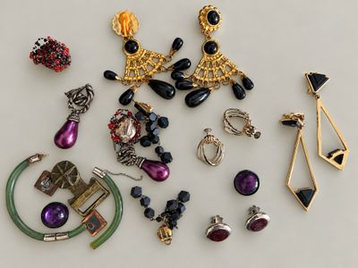 many different types of jewelry on a white surface