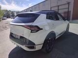 the rear end of a white suv parked in front of a building