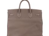 a brown leather handbag on a white background