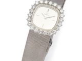 a lady ' s wrist watch with diamonds and a leather band