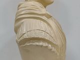 a white bust of a man with a scarf on it