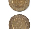 two gold plates with a picture of a man and a woman on them