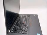 a laptop with a black keyboard on a white surface