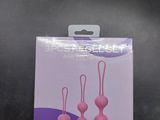 a package of three pink hair clips on a black surface