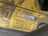 a close up of a yellow gas pump on the back of a truck
