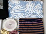 an assortment of clothing and accessories laid out on a table