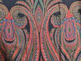 an image of a black shawl with red and green paisleys on it
