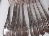 a lot of forks and spoons that are on the table