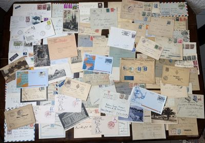 a table with many old letters and stamps on it