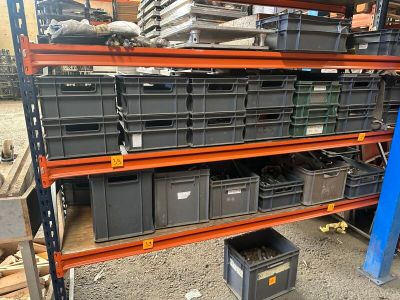 many bins and boxes on the shelves in the warehouse