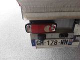 a red suitcase sitting on top of the back of a truck