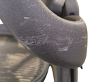 a close up of a chair with a seat and arm rest