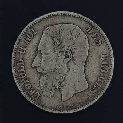 a close up of a coin with a man ' s face on it