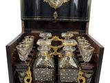 an image of a black and gold decorated chest of liquor glasses