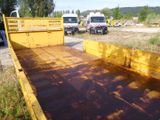 a yellow truck that is parked on the side of the road