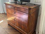 a wooden dresser with a television on top of it