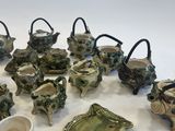 many different types of teapots and cups on the table