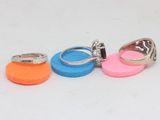 four different colored rings sitting on top of each other on a white surface