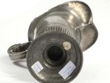 a silver vase that has a label on it