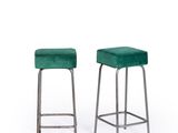 a pair of green velvet stools with metal legs