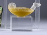 a glass bowl with a yellow liquid inside of it