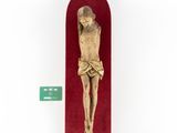 an old wooden crucifix with a red velvet case and a green tag