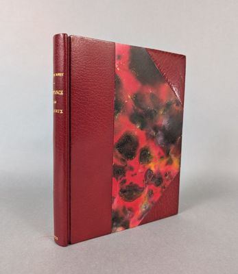 a book with a red cover sitting on top of a table