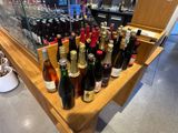 many bottles of wine sitting on a table in a store