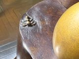 a large orange sitting on top of a wooden chair