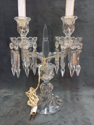 pair of crystal candelabs with candle holders on a table