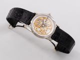 a watch that is on a black leather strap
