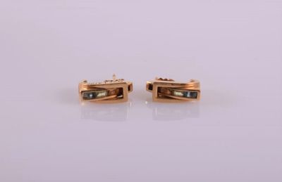 a pair of gold plated earrings with black stones