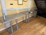 two tables that are sitting on the floor in the room