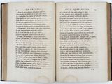 an open book on a white surface with a black border