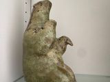 a sculpture of a bear head hanging on a wall
