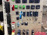 a display of various cell phones on the wall in a store